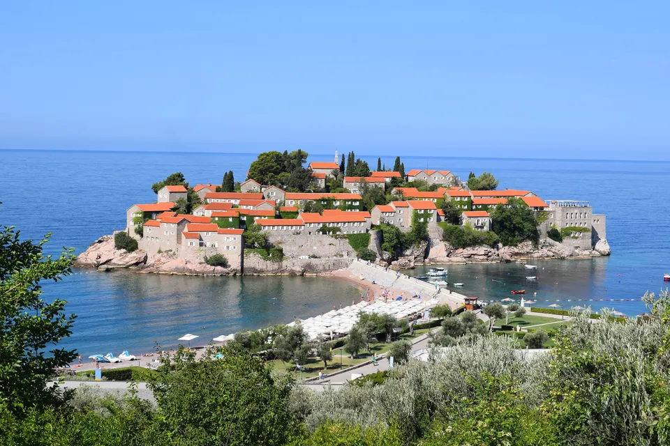 Red-roofed islet village of Sveti Stefan connected to the coast by a narrow sandbar