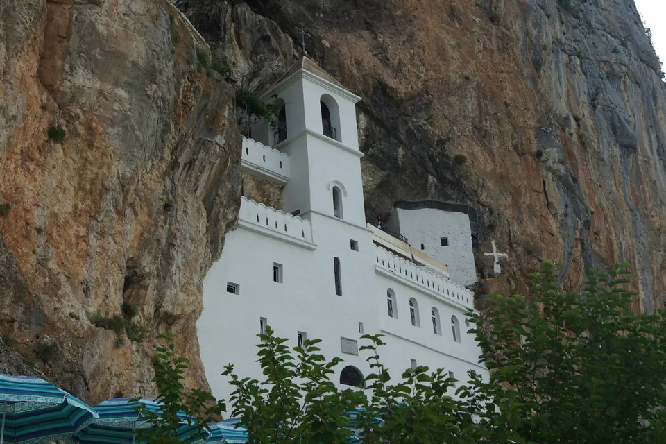 Ostrog Monastery carved into the cliff face above the Bjelopavlići plain, Danilovgrad municipality.