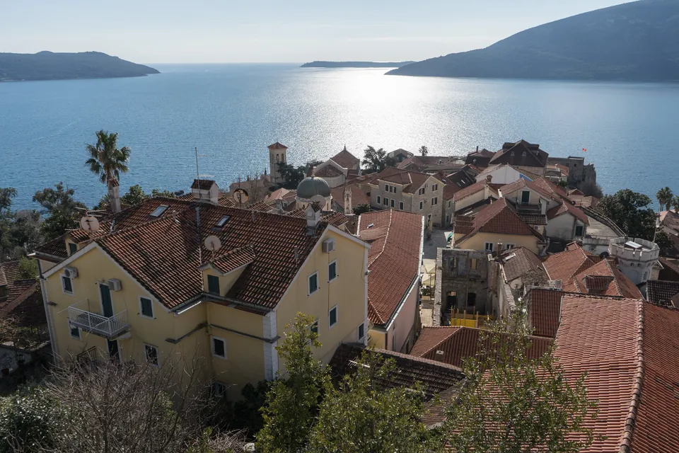 Terracotta rooftops of Herceg Novi's old town seen from Kanli kula fortress above the bay