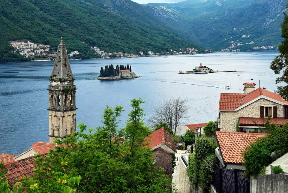 View from Perast's bell tower over rooftops toward the islets of Our Lady and Saint George