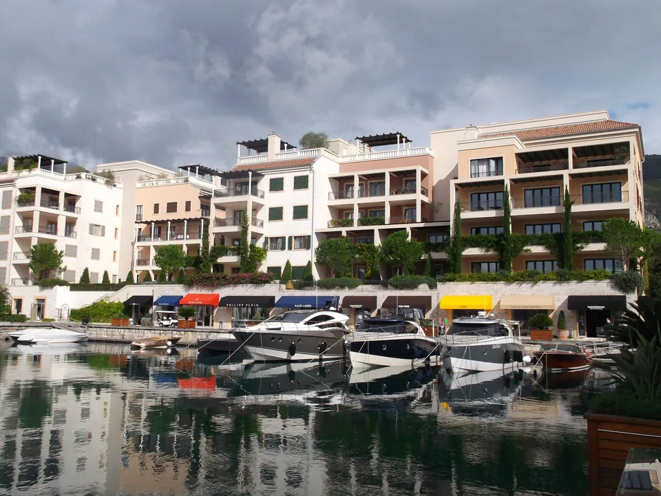 Waterfront residential buildings and boutique awnings along the Porto Montenegro promenade in Tivat