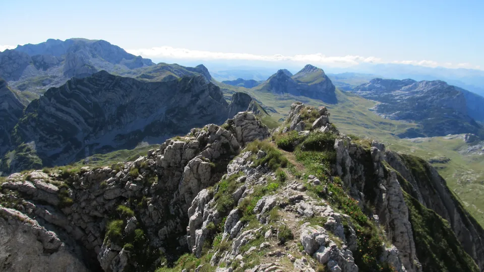 Rocky ridge trail on Prutaš with jagged Durmitor peaks stretching to the horizon