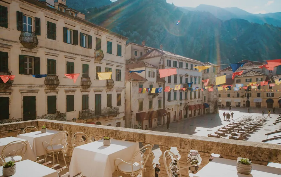 Terrace tables above the Old Town square with the mountain behind