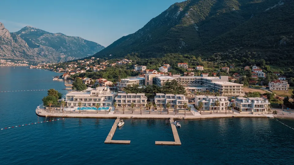 Aerial view of the resort and its piers on the bay below the mountains