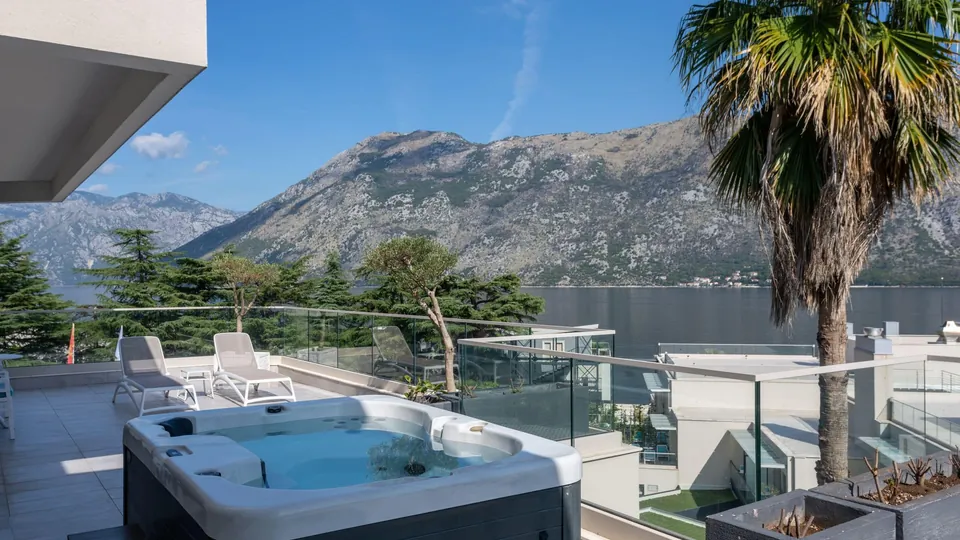 Suite terrace with a hot tub and a view across the bay