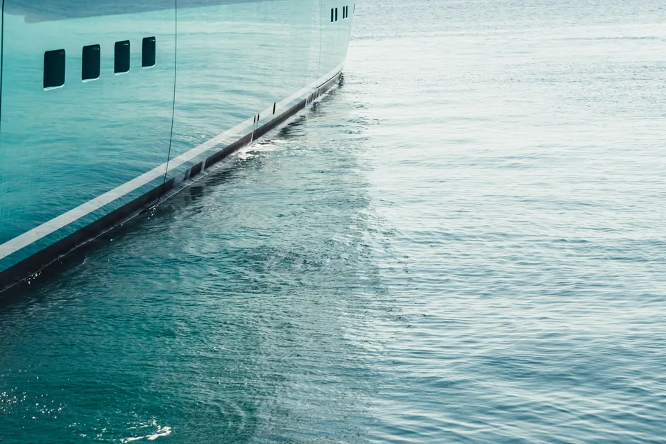 Hull of a large yacht on calm sea