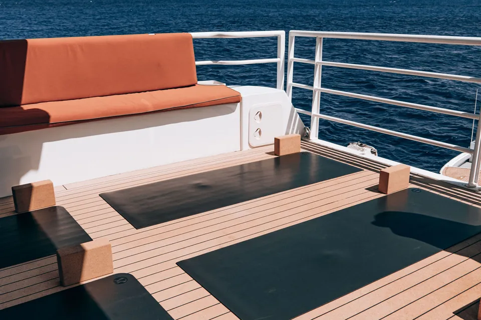 Yacht deck with yoga mats above the open sea