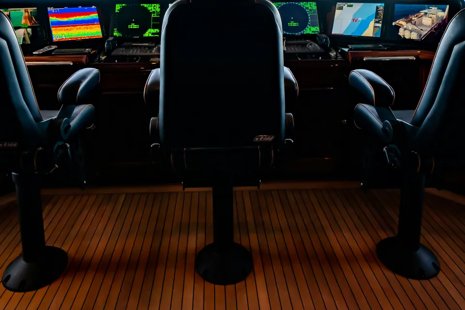 Yacht bridge with helm chairs and navigation screens