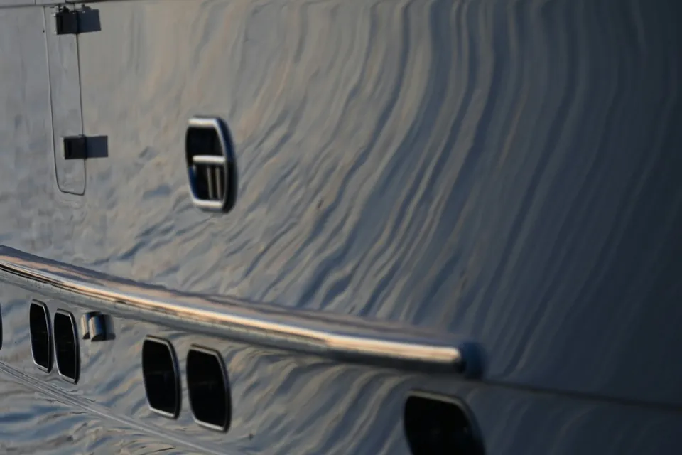 Polished yacht hull reflecting the evening sky