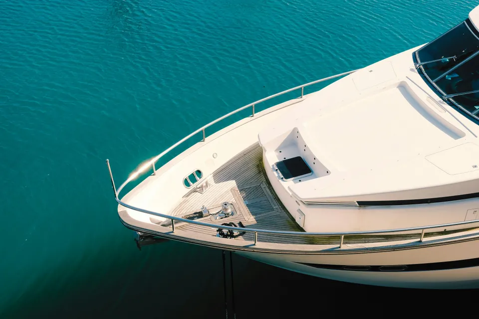 Bow of a motor yacht above clear water