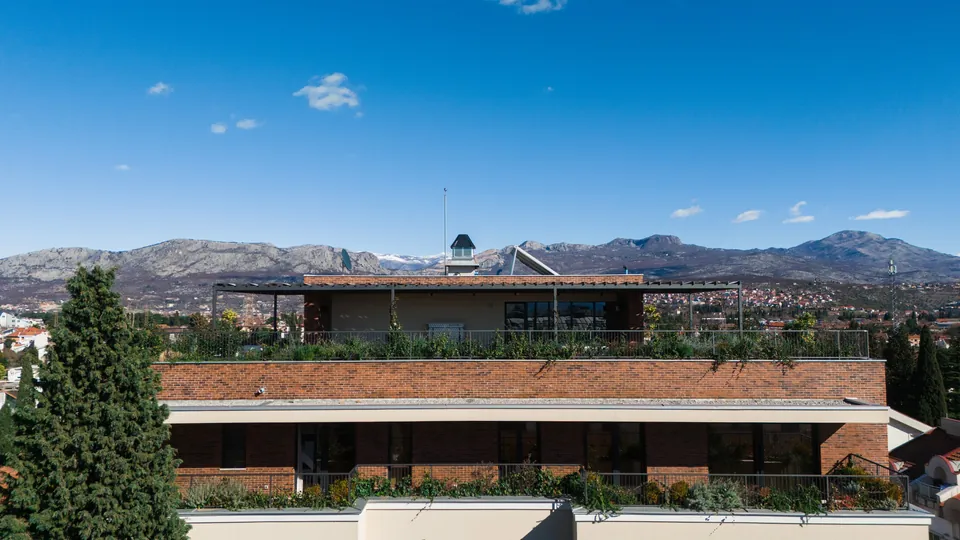 Penthouse roof terrace with the mountains behind