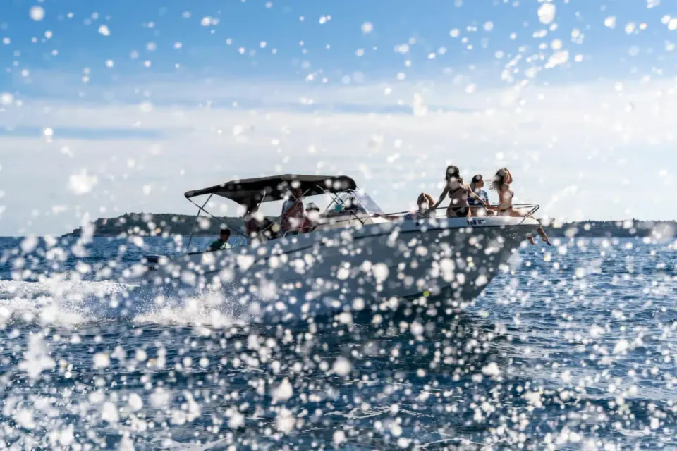 Speedboat throwing spray across open water