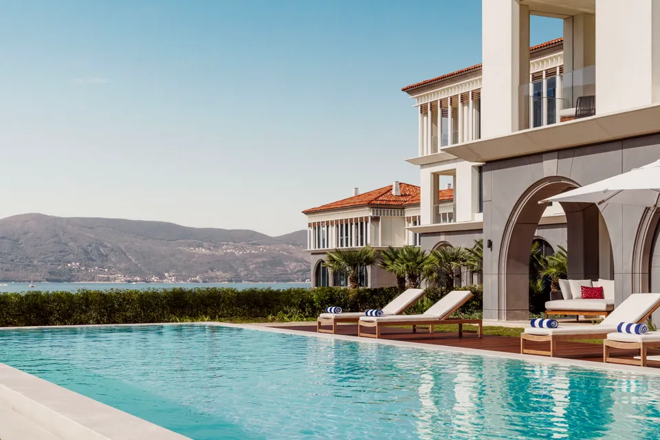 Main pool and sun loungers beside the bay