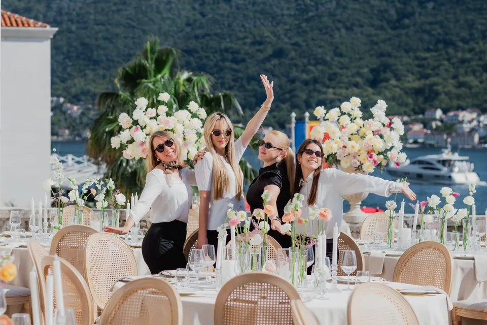 The planning team beside a table set for a celebration by the bay