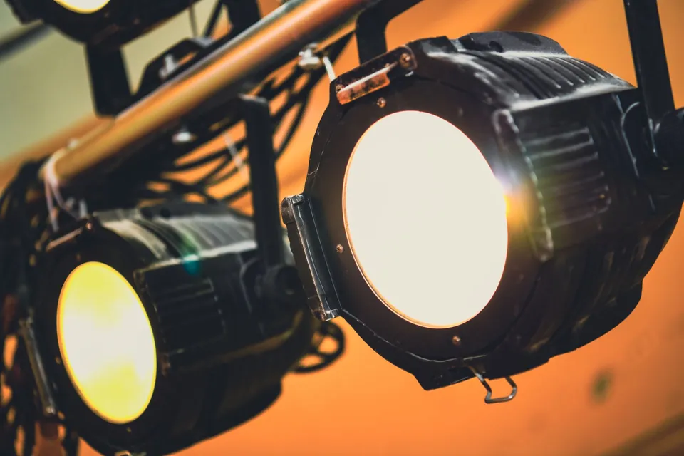 Two stage spotlights mounted on a lighting bar